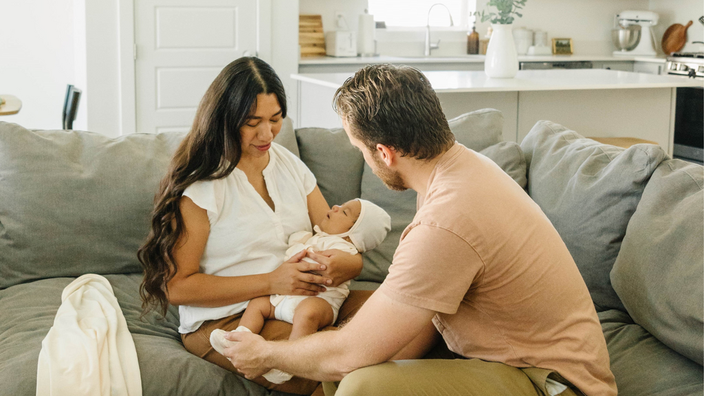 father and mother with their baby in the living room