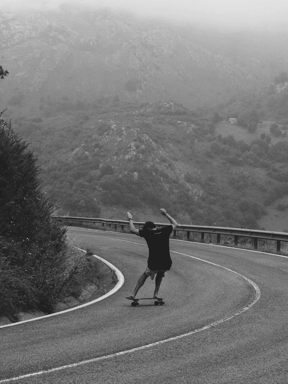 man surfing a street in picos de europa with carver skateboard 