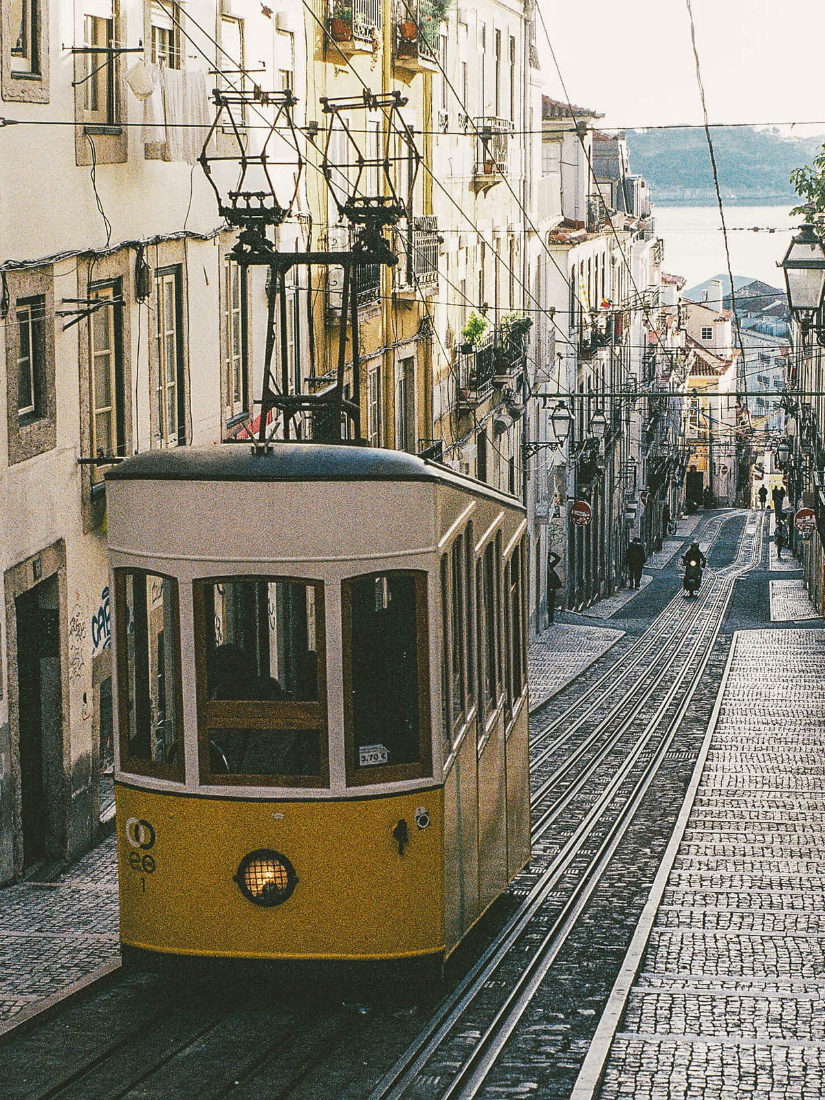 Tram 28 mit Barrio Alto und dem Tejo im Hintergrund