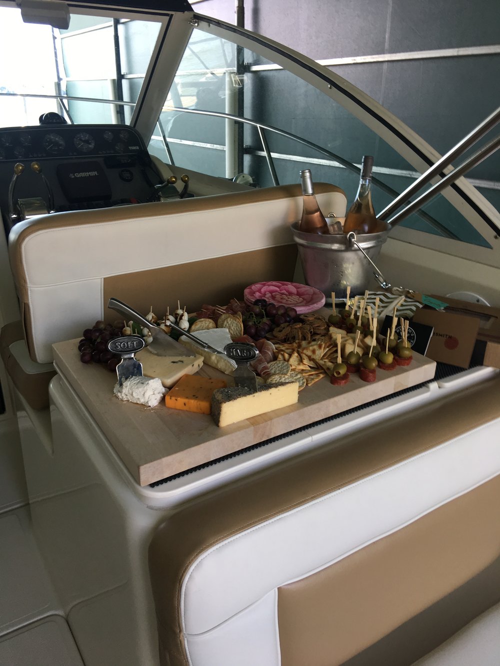 charcuterie wine cheese snacks on a boat