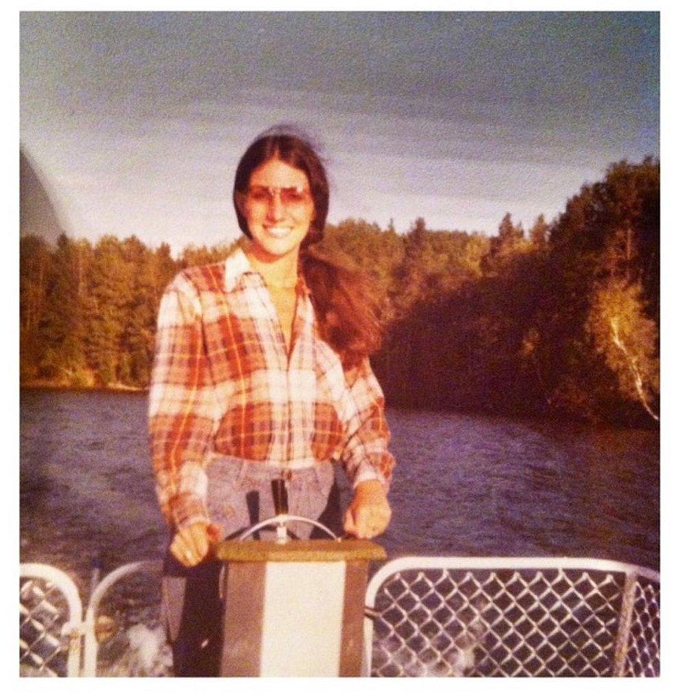  Vintage photo of woman driving a boat 