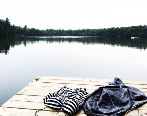 clothes laying the dock with the lake in background