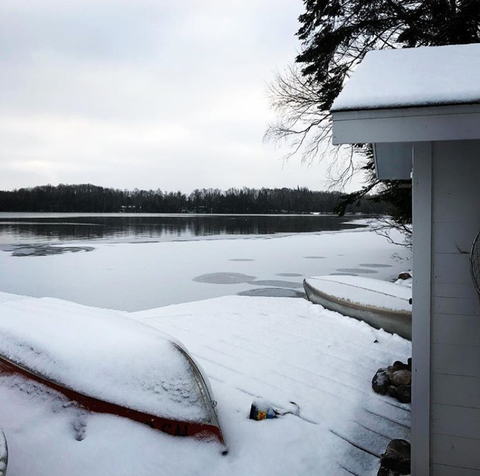 snow covered lake and canoes