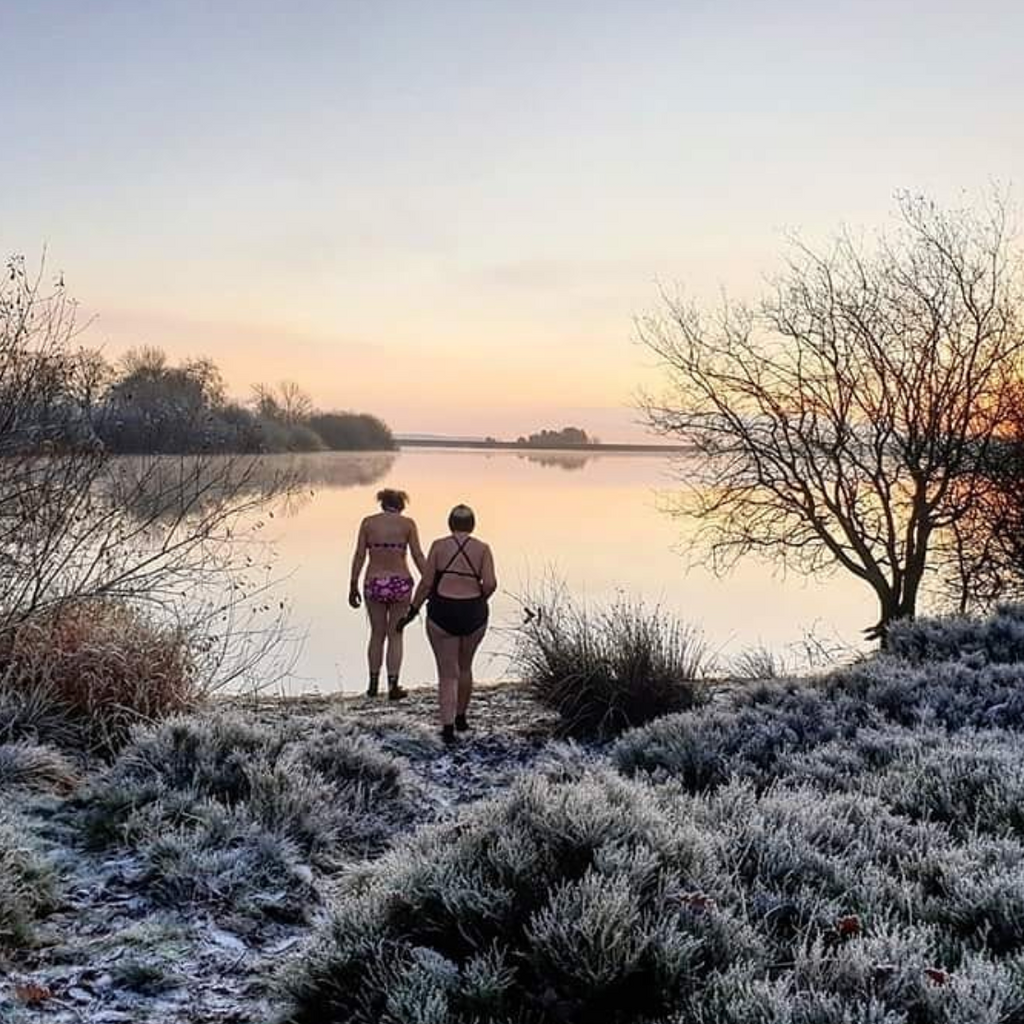Two Girls Swimming in a cold lake during winter swim club