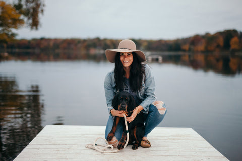 woman and her dog on the pier