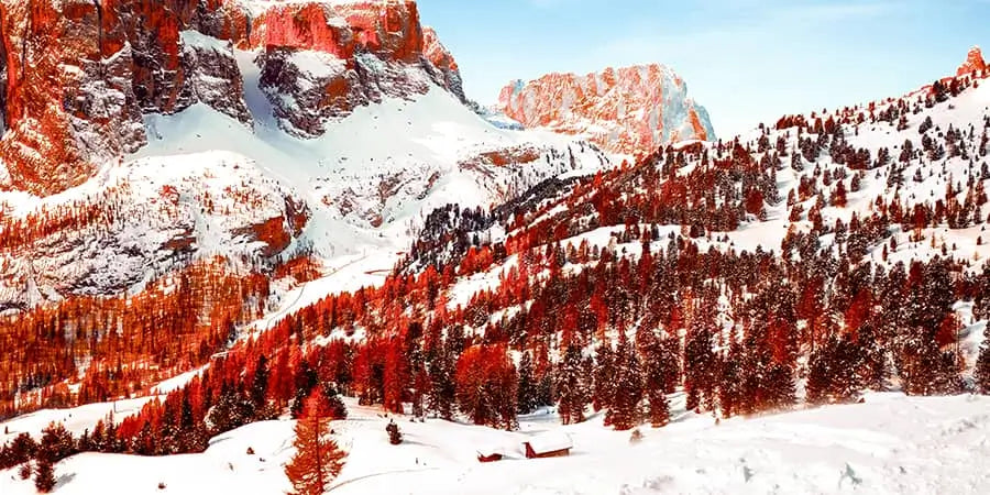 The Dolomites, Italy's most beautiful mountain range, and the craggy, rose-tinted Dolomites belle Bella against a winter blue sky.