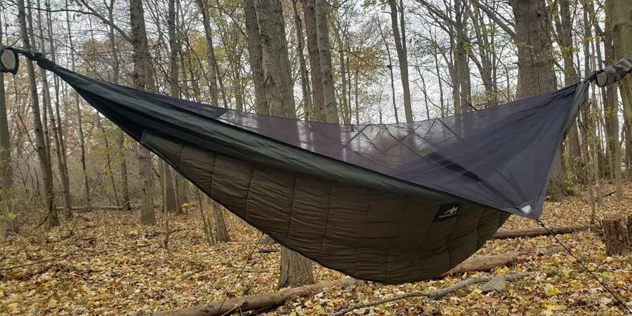 Ayamaya camping hammock in the woods between two trees