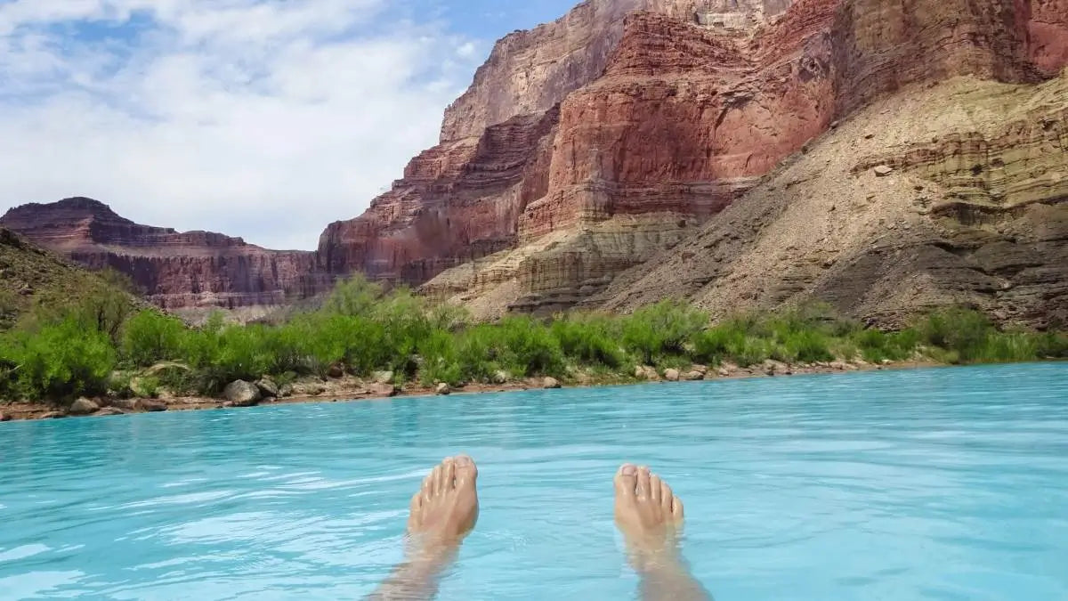 man in body of water with feet exposed