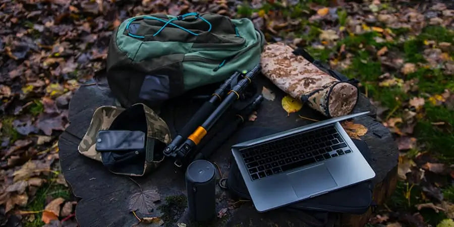 camping gear organized for display on a black rock outdoors