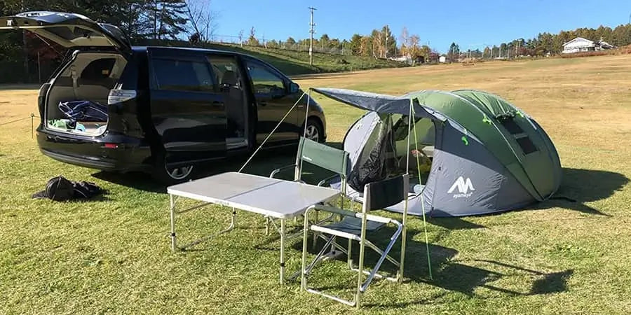 Car camping set up in a field
