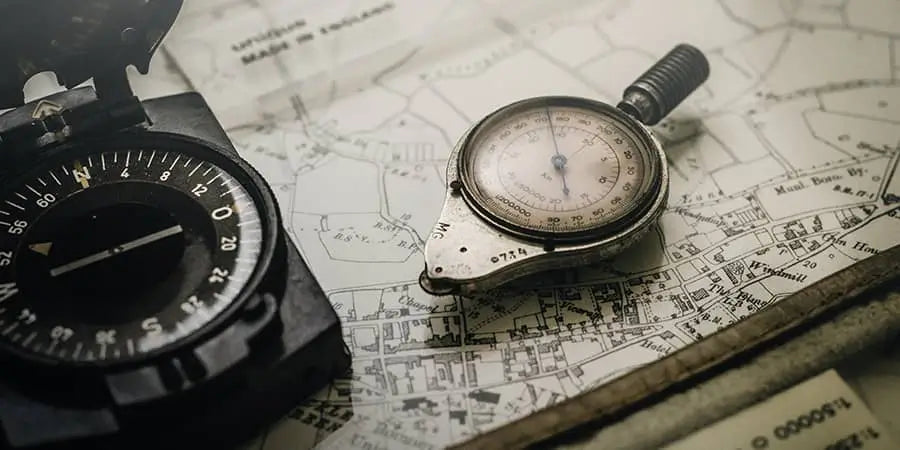 Compass on a map looking at navigational coordinates