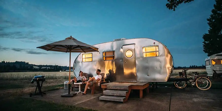 couples camping with mobile trailer