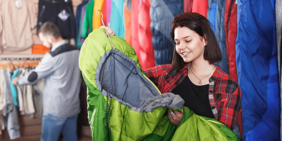 Woman in the store searching for a sleeping bag