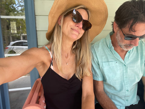 couple at beach house wearing sunglasses