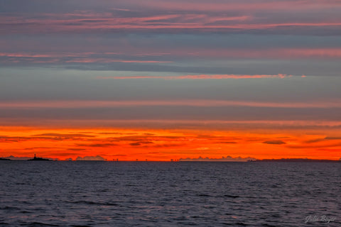 Coastal mountains framed by orange dawn light