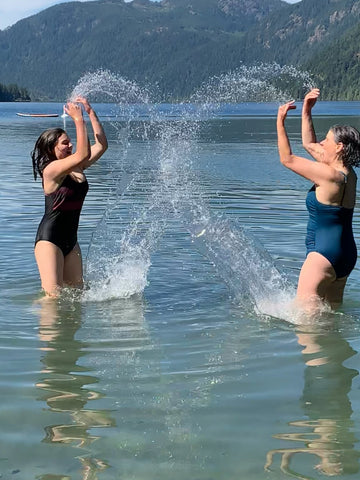 Mother and daughter splashing in the lake