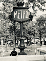 Black and white photo with a Paris Metro sign