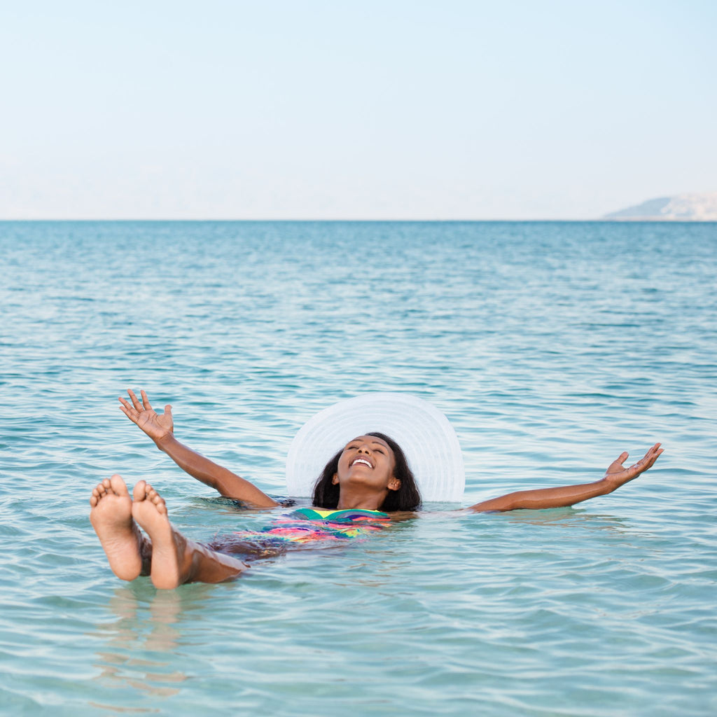 Woman floating in the Dead Sea