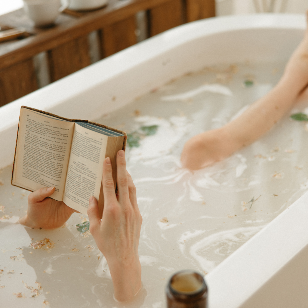 Woman relaxing and reading in a Dead Sea Salt bath