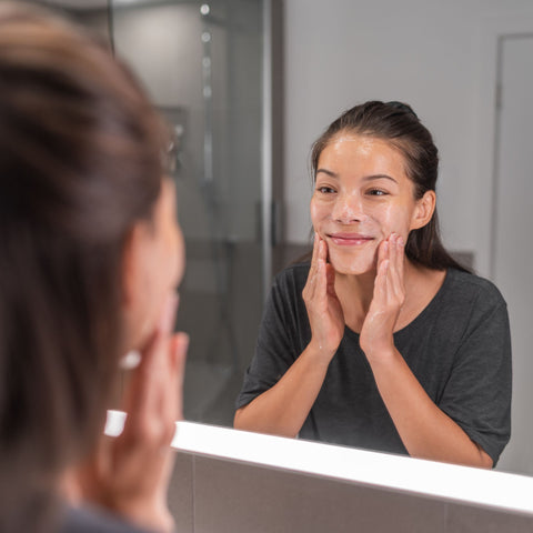 Woman cleansing her face