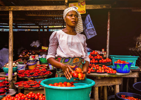 African woman wearing colorful print skirt