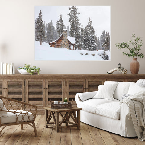 Cozy house setting with large canvas of snow covered cabin on the wall fine art