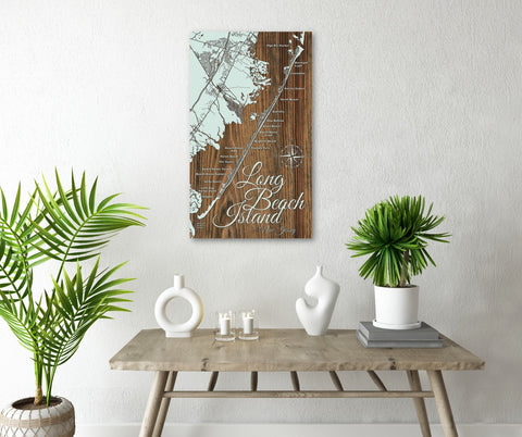 a beautifully made, intricate wood wall map sits above a small, decorated table with greenery and home decor.