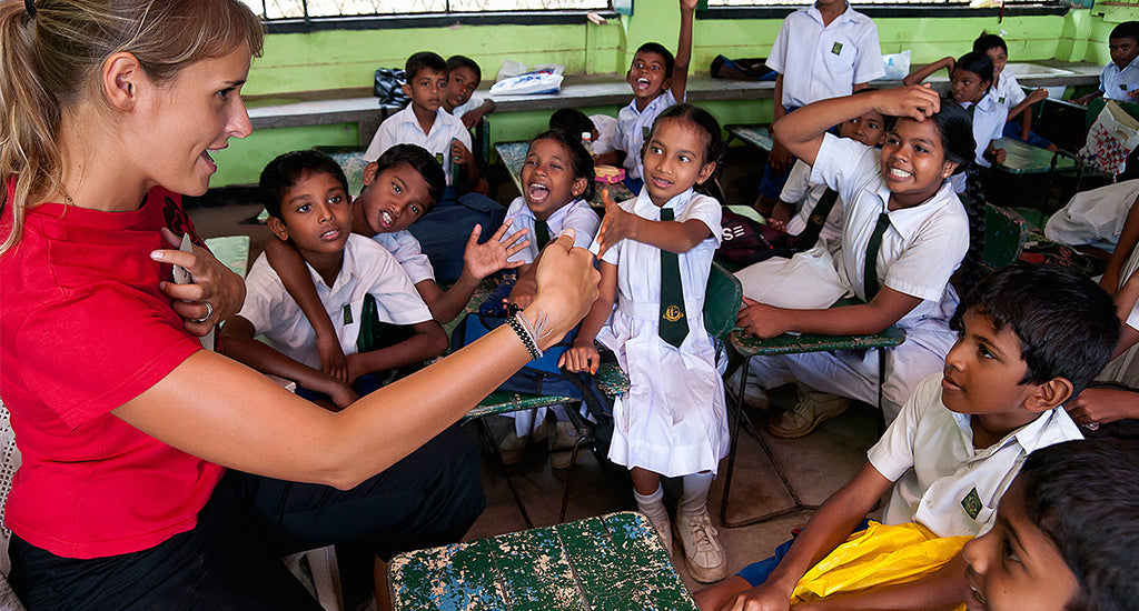 A teacher teaching children in a school in Sri Lanka mischa blog