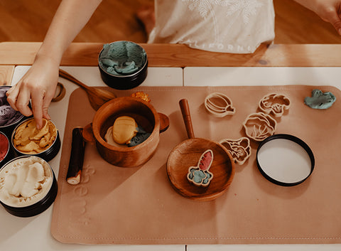 Vegetable playdough cutters being used with pots and pans toddler play set up by Kinfolk Pantry