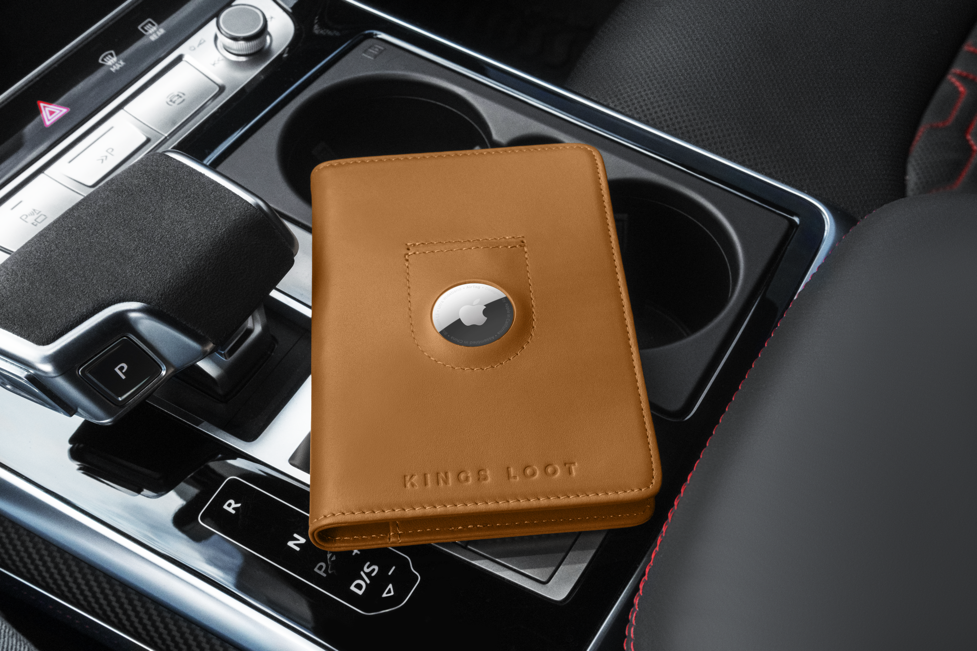 A brown leather wallet with a tracking device on a car console.