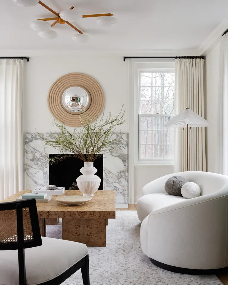 Curved sofa in a living room with floor to ceiling windows