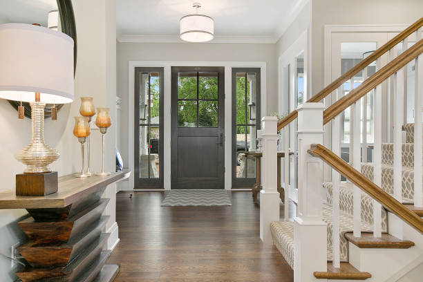 Light entryway with grey door and natural wood console table