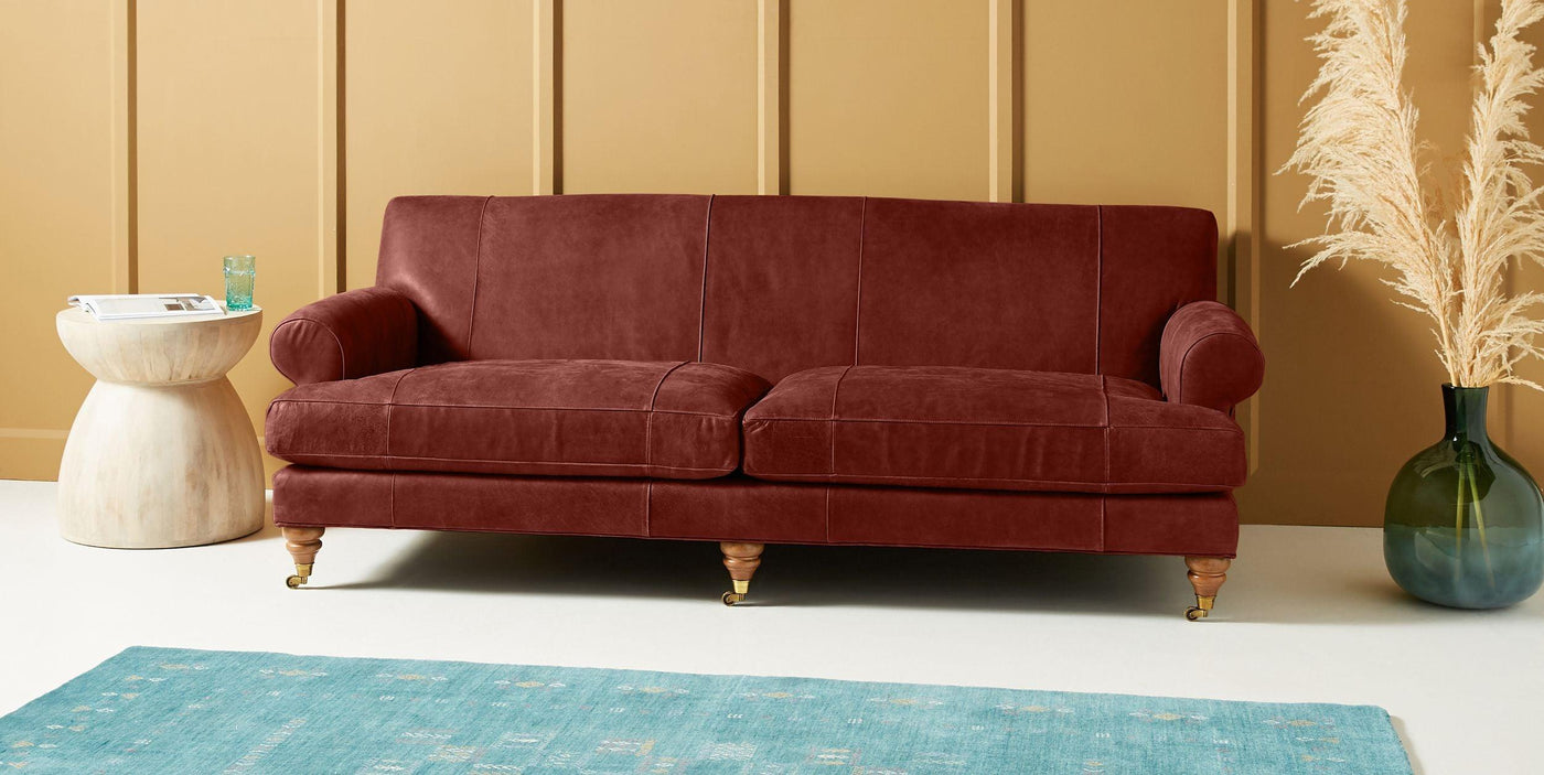 Dark brown leather sofa in a light cream room