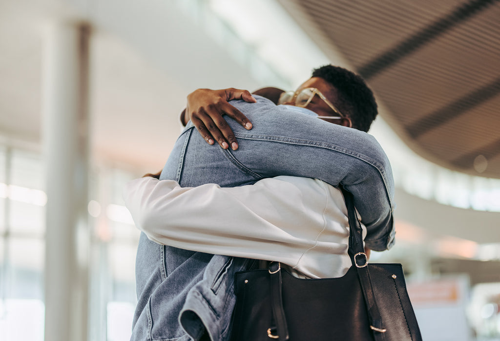 Stock photo of a couple meeting at airport arrival gate