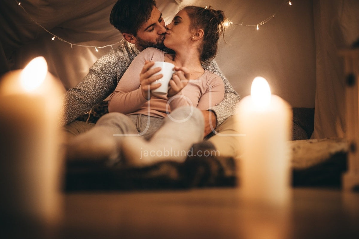Romantic couple kissing each other sitting on bed – Jacob Lund ...