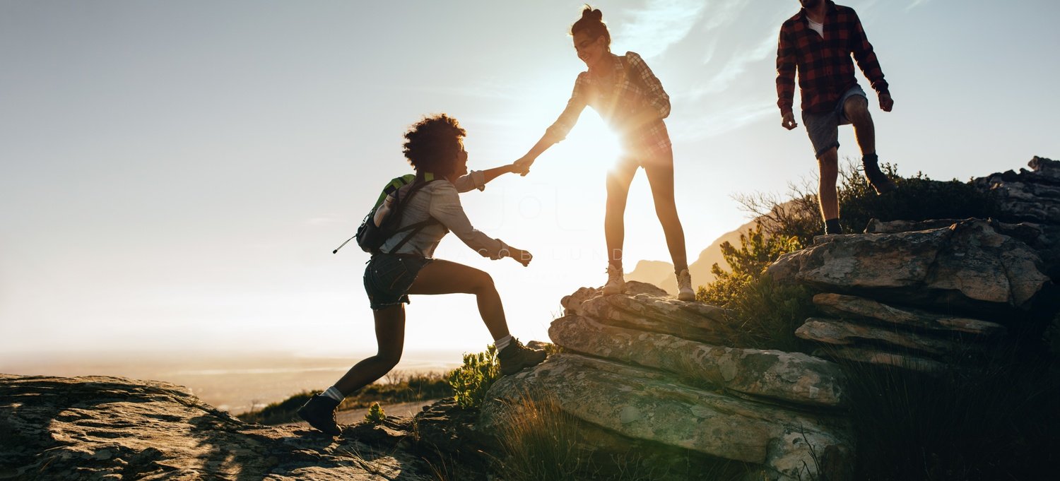 Helping each other hike up a mountain – Jacob Lund Photography Store-  premium stock photo