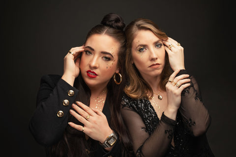 Image shows sisters Casey and Janine Melvin displaying their many THEFUTUREOFJEWELRY custom signet rings