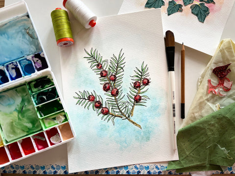 Original Embroidery Art by Francesca Kemp Textile Art featuring a Yew sprig and orange/red berries on my painting desk