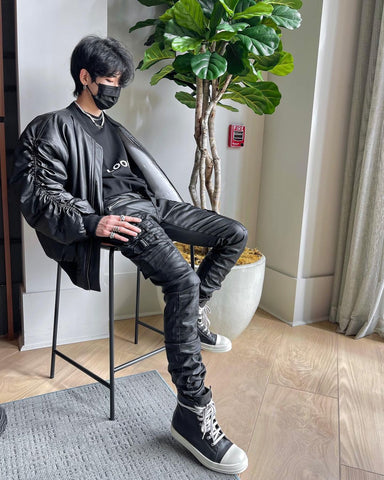 Men streetwear outfit ideas - black leather jacket, mask, stacked pants, high top sneakers