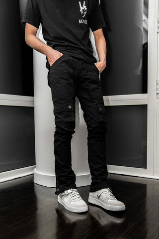 Black shirt, denim cargo pants, and white sneakers outfit for men