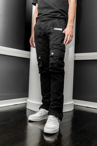 A man putting a phone inside the pocket of black straight cut cargo denim jeans