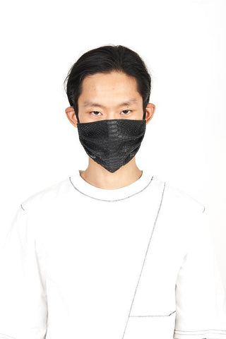 A man wearing vegan python leather black face mask with white tee shirt outfit