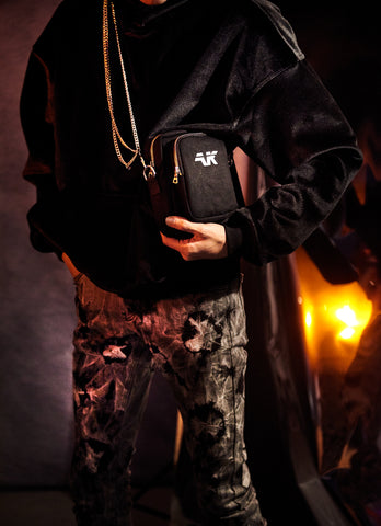 Crossbody shoulder bag styled with pants chains and velour hoodie
