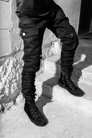 Solid black outfit cargo pants stacked denim and black high top sneakers men