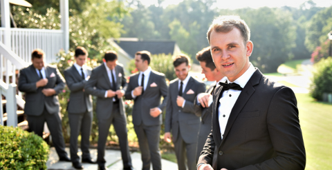 Groom and groomsmen in suit and black tie