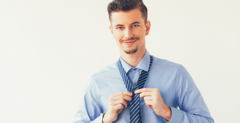 a men is trying to tie a necktie