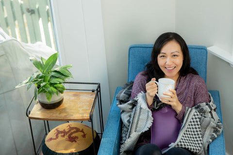 woman drinking tea relaxing sleep hygiene