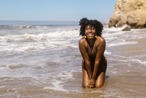 woman on beach laughing