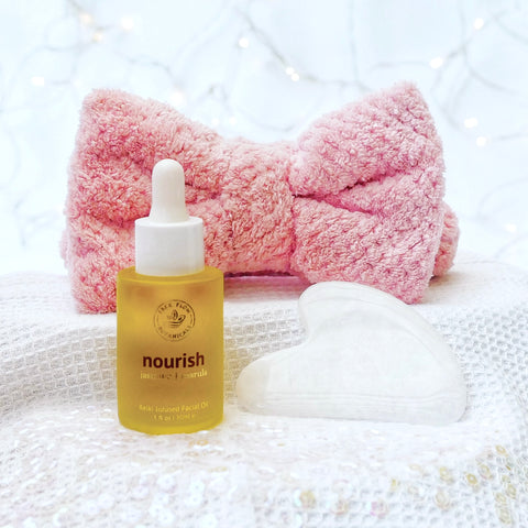 Gemstone Ritual Kit with white jade gua sha heart shaped tool, Nourish Facial Oil and a fluffy spa headband