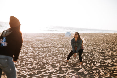 two women playing beach volleyball